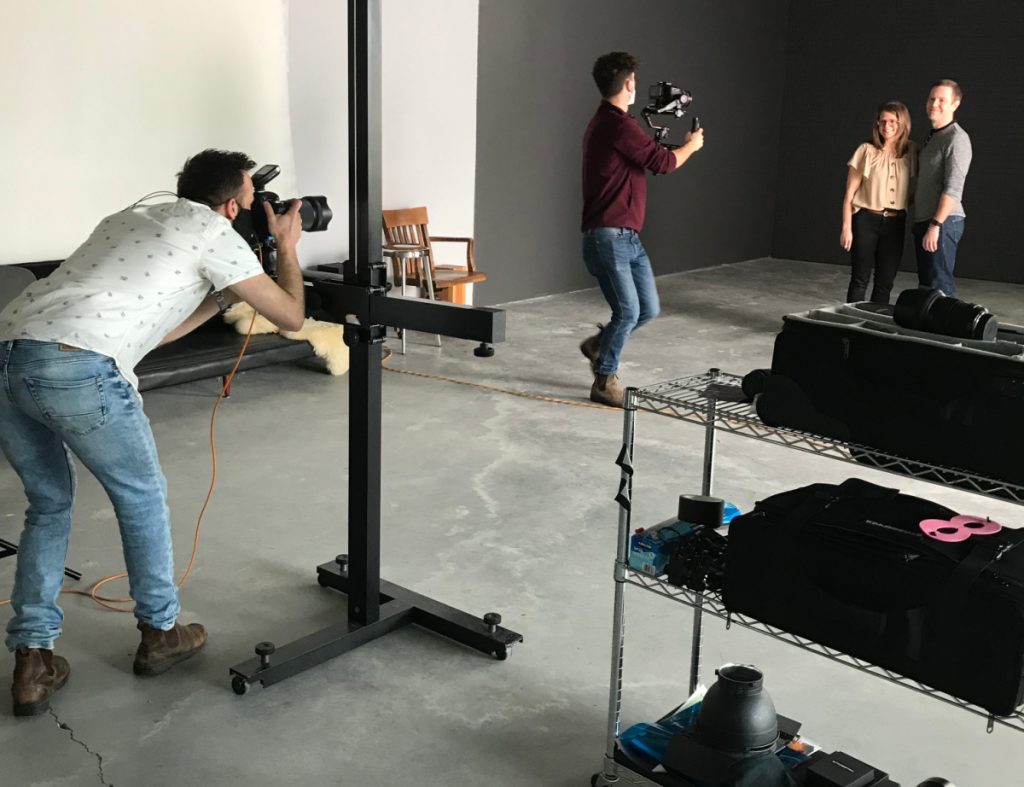 photographer and videographer in studio with man and woman